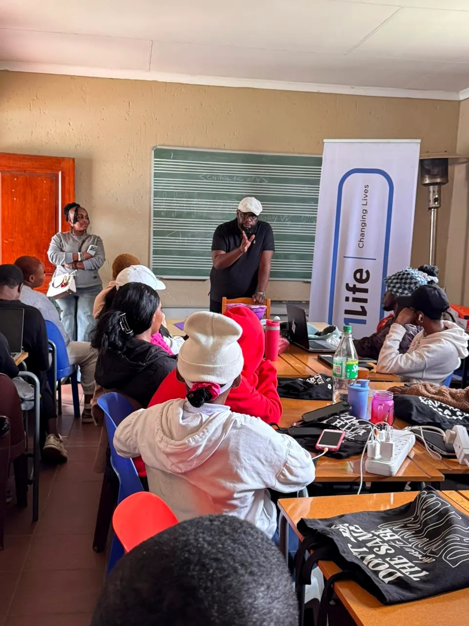 Sicelo presenting a training session to a full classroom